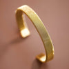 Gold mesh bracelet on a blurred background