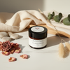 Skincare jar with decorative elements on a light surface