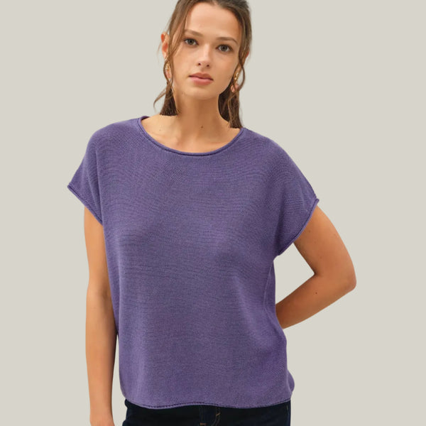Woman wearing a purple t-shirt against a white background