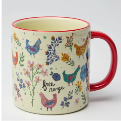 A ceramic mug with a cream-colored body, decorated with colorful illustrations of free-range chickens and plants, featuring a red handle and red rim.