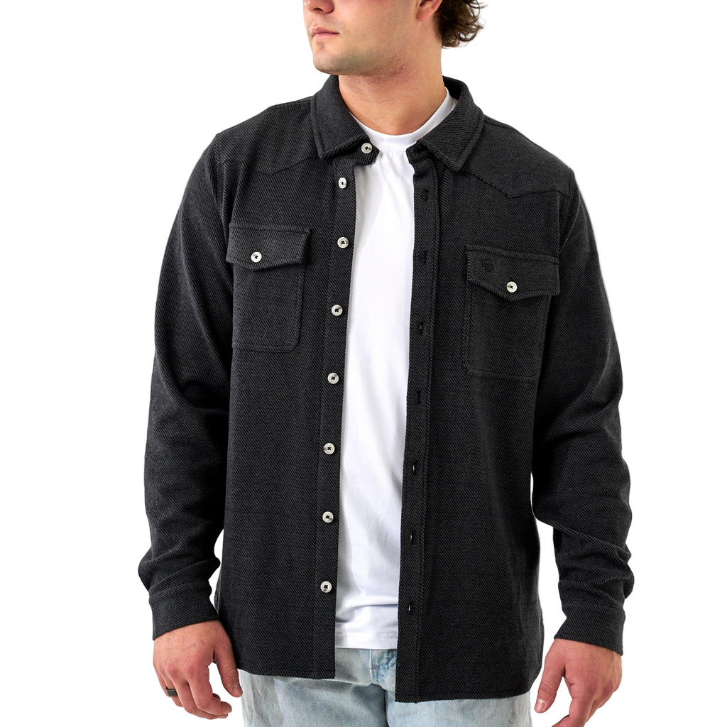 Man wearing a black button-up shirt over a white t-shirt on a white background