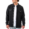 Man wearing a black button-up shirt over a white t-shirt on a white background