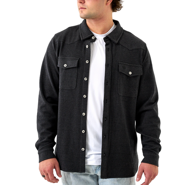Man wearing a black button-up shirt over a white t-shirt on a white background