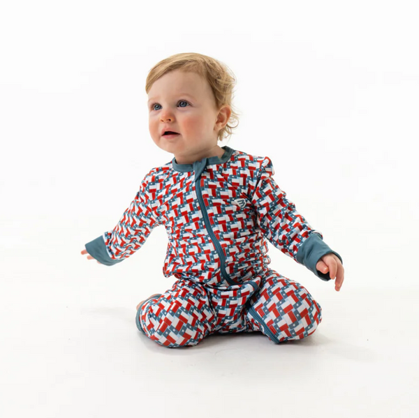 Baby wearing a patterned onesie on a white background