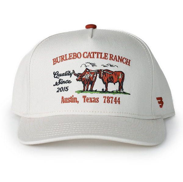 White cap with Burlebo Cattle Ranch branding on a white background