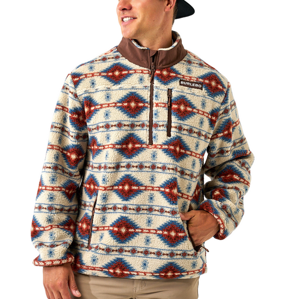 Person wearing a patterned pullover with a visible brand logo on a white background