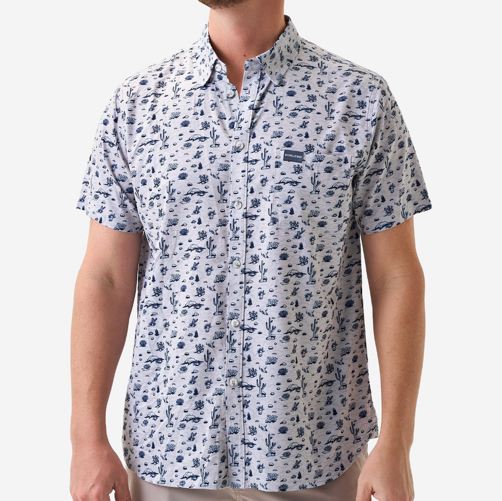 Man wearing a short-sleeve shirt with a blue pattern on a white background