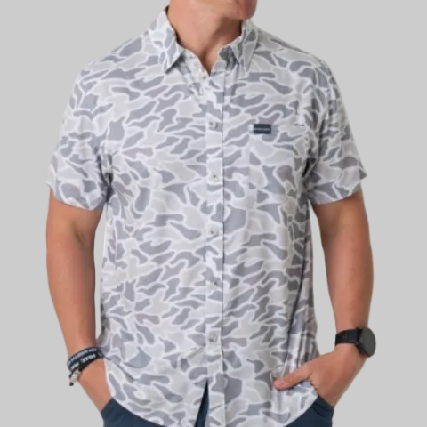 a man wearing a button up with grey and white camo