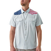 Man wearing a white shirt with American flag designs on the shoulders against a white background