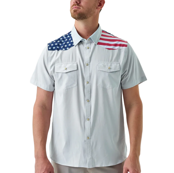 Man wearing a white shirt with American flag designs on the shoulders against a white background