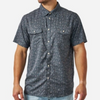 A man wearing a short-sleeve button-up shirt with a dark blue and gray paisley pattern, paired with light blue jeans, shown against a plain white background.