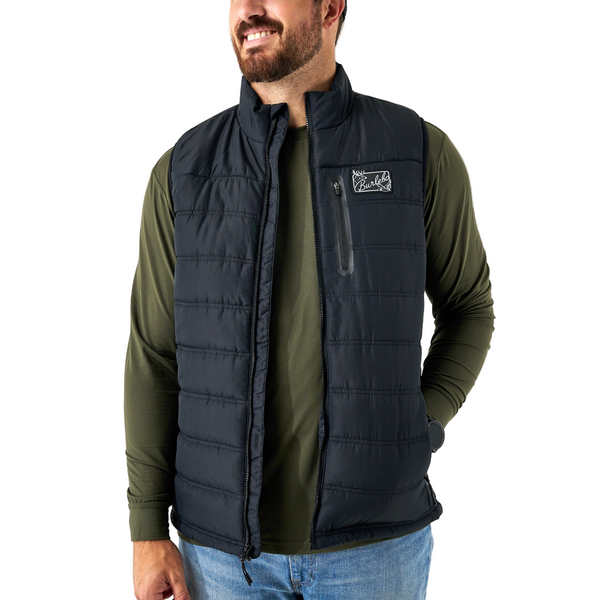 Man wearing a black puffer vest over an olive green shirt on a white background