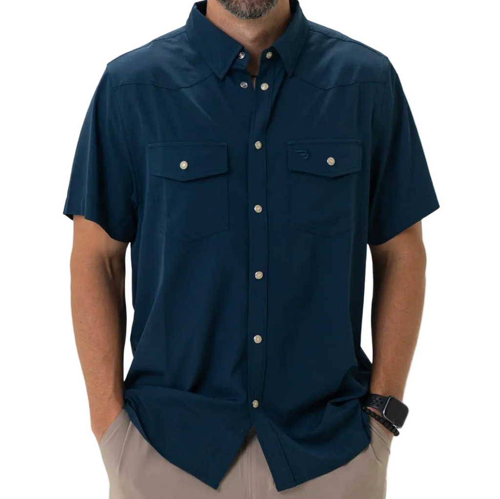 Man wearing a navy blue short-sleeve shirt with button details on a white background