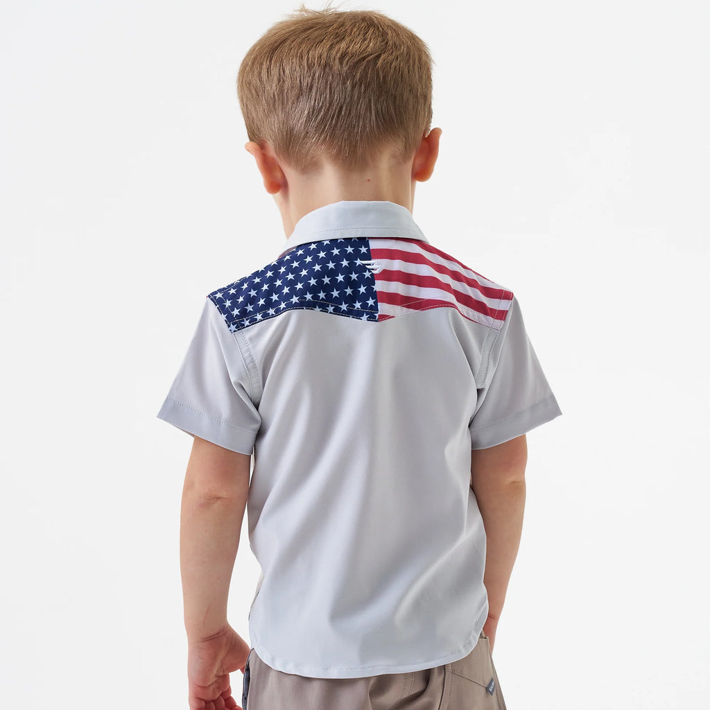 Child wearing a polo shirt with an American flag design on the back