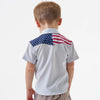 Child wearing a polo shirt with an American flag design on the back