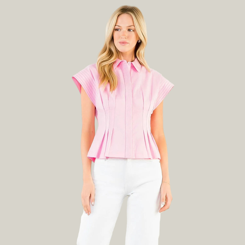 Woman wearing a pink blouse with a white background