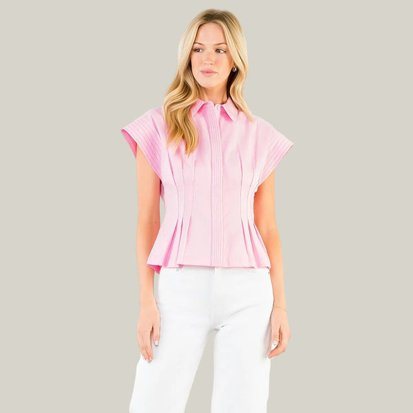 Woman wearing a pink blouse with a white background
