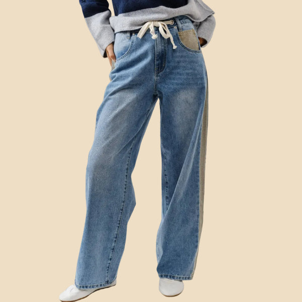 Person wearing blue jeans with a white background
