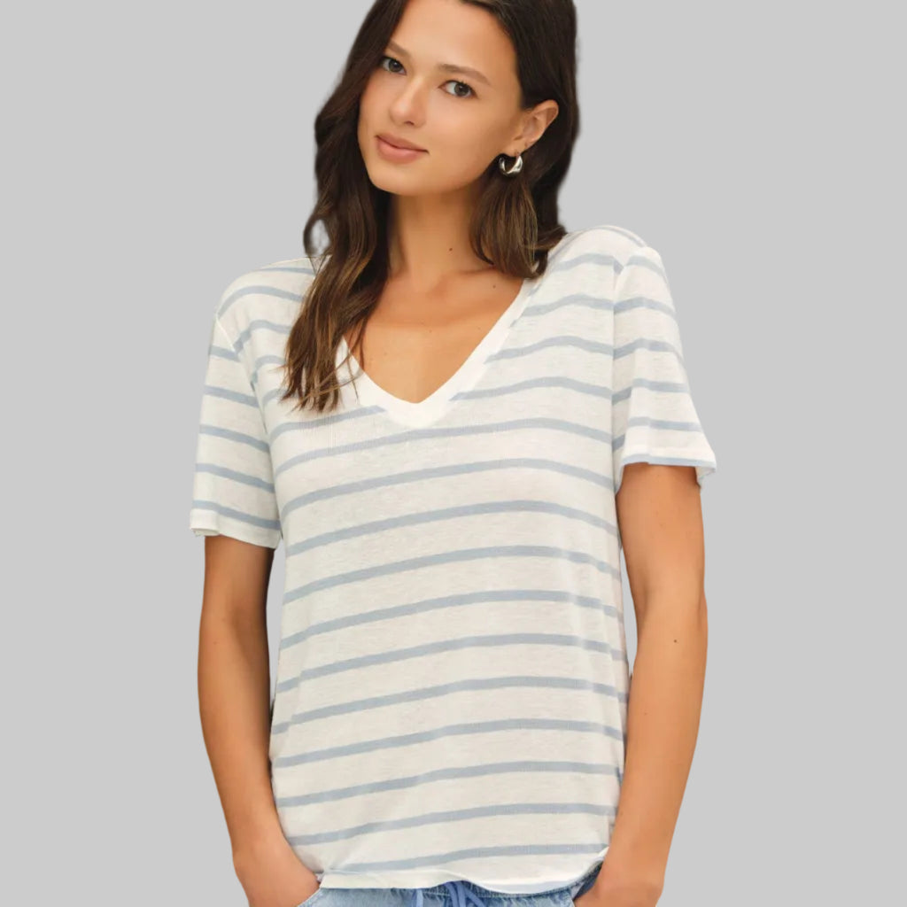 Woman wearing a striped t-shirt against a neutral background