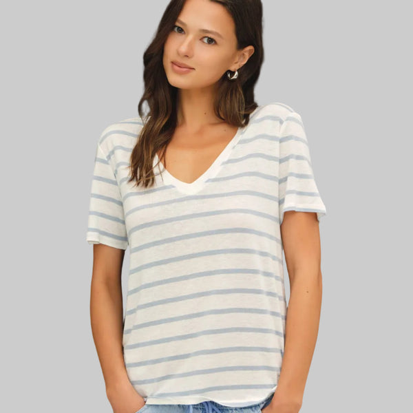 Woman wearing a striped t-shirt against a neutral background