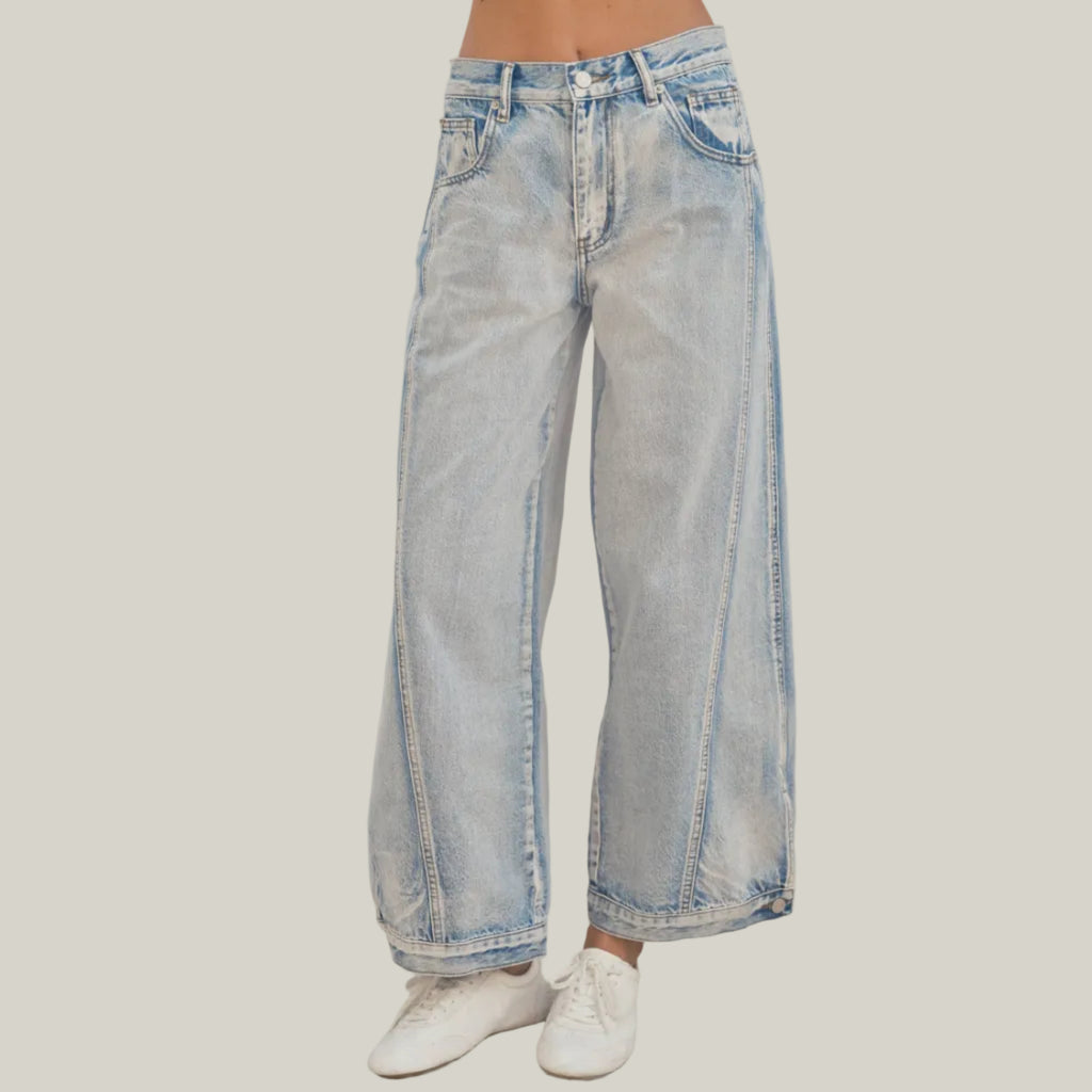 Light blue jeans worn by a person on a neutral background