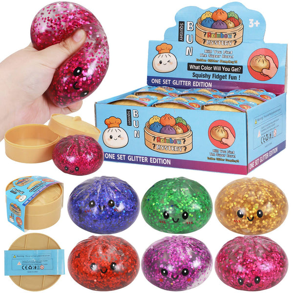 Colorful glittery balls with faces and packaging on a white background