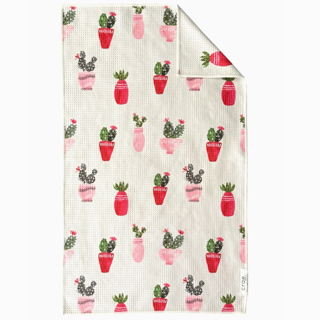 Folded fabric with cactus pattern on a white background