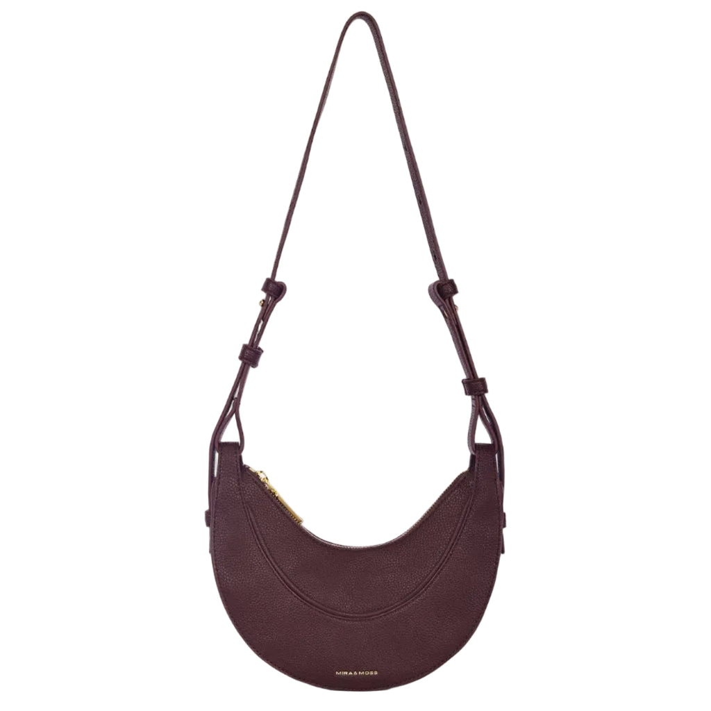 Purple shoulder bag with a strap on a white background