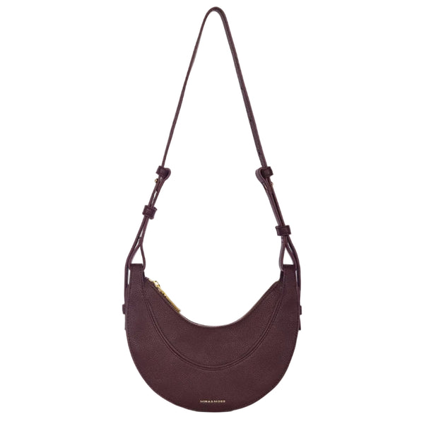 Purple shoulder bag with a strap on a white background