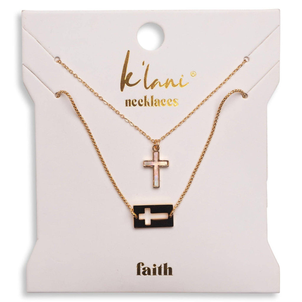 Two necklaces with cross pendants on a 'klani' branded card.