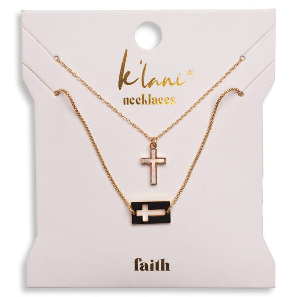 Two necklaces with cross pendants on a 'klani' branded card.