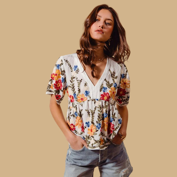 Woman wearing a floral blouse with a beige background