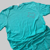 Teal t-shirt with a logo on a granite countertop