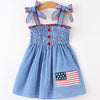 Children's dress with American flag patch on a white background