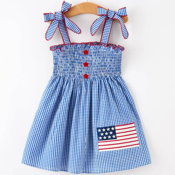 Children's dress with American flag patch on a white background