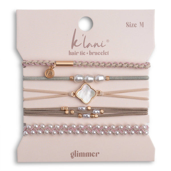 Set of hair ties and bracelets on a 'klari' branded card with 'glimmer' text.