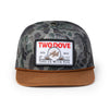 Camouflage cap with a 'Two Dove' logo on a white background