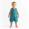 Baby wearing a blue romper with animal prints on a white background