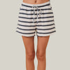 Striped shorts worn by a person on a beige background