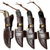 Four brown leather knife sheaths with decorative stitching on a white background