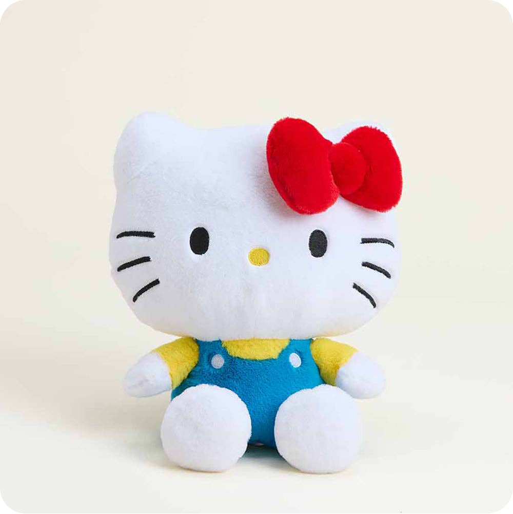 Plush toy resembling a character with a red bow on a light background