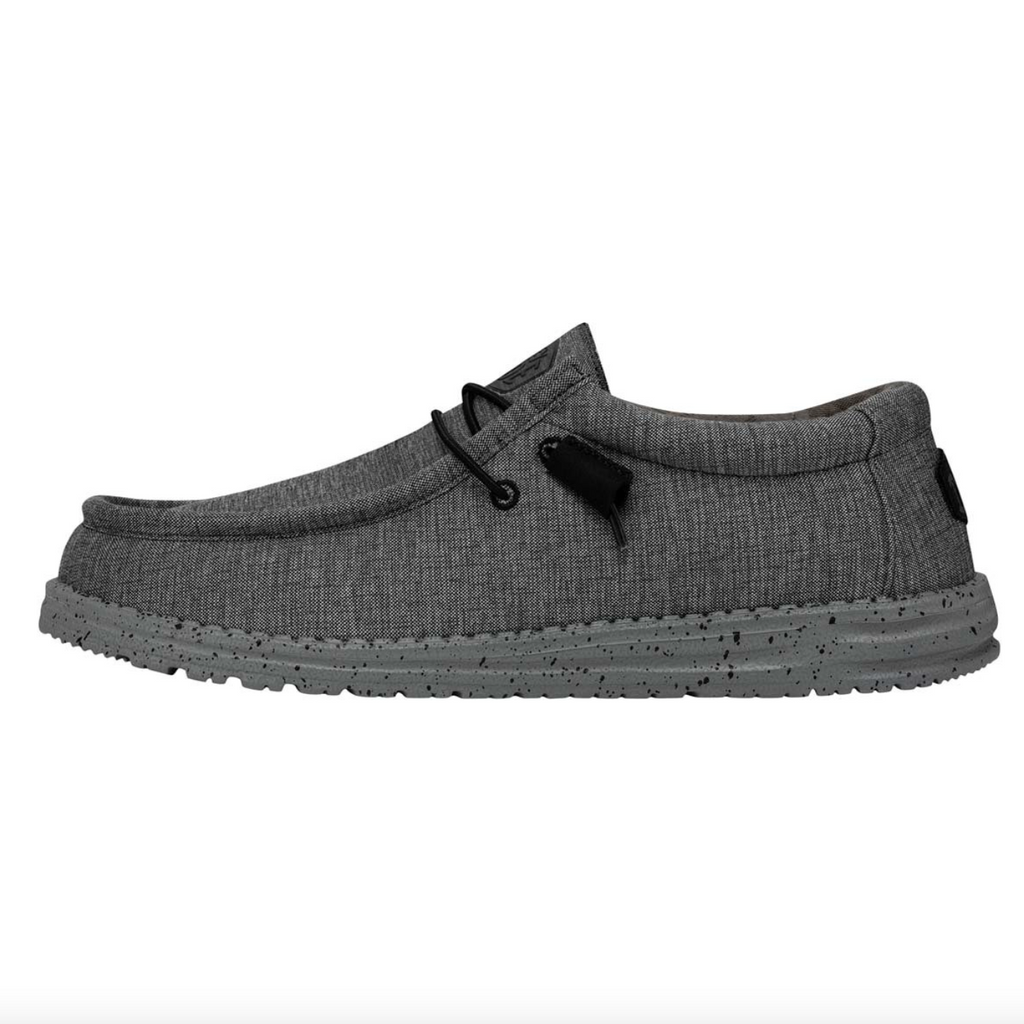 Gray shoe with black laces on a white background