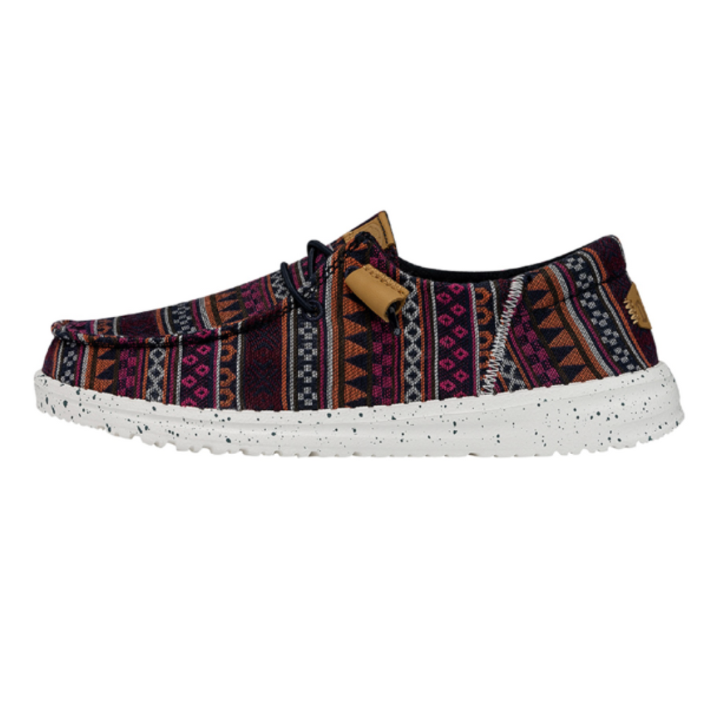 Sandal with patterned strap and white sole on a white background
