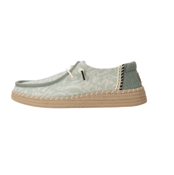 Green casual shoe with patterned design on a white background
