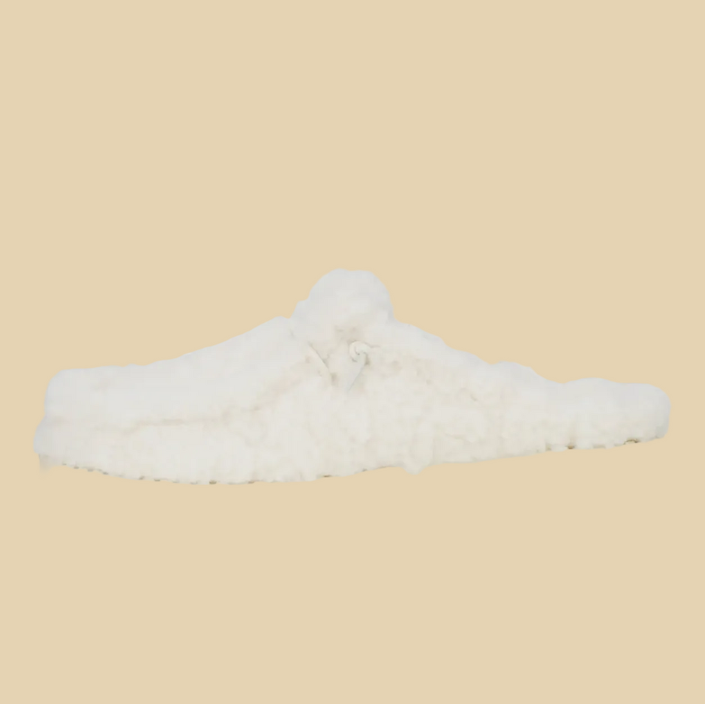 White fluffer slip on on beige background
