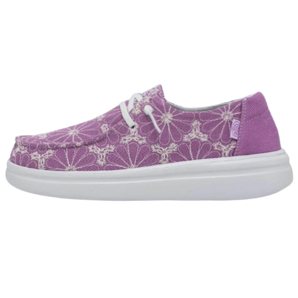 Purple sneaker with white floral pattern on a white background