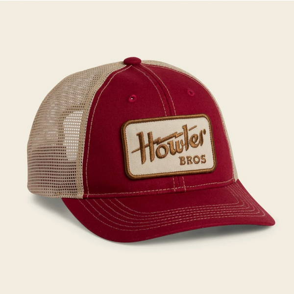 A maroon and beige trucker hat with a tan leather patch on the front that reads 'Howler Bros'.
