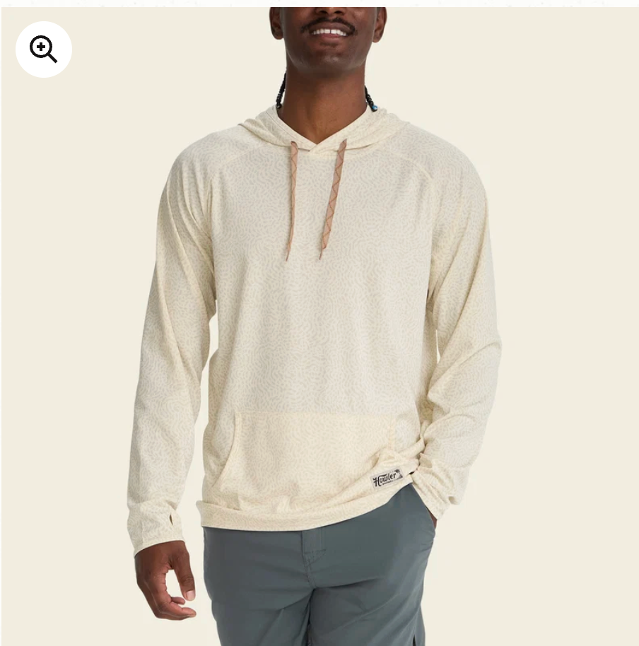 Man wearing a bone performance hoodie on a neutral background
