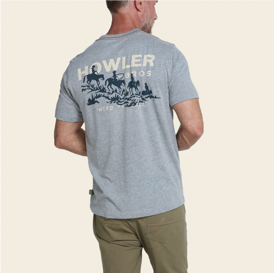 Man in a grey tshirt that reads Howler Bros and has shorses