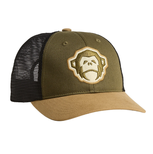 Green and brown cap with a monkey logo on a beige background